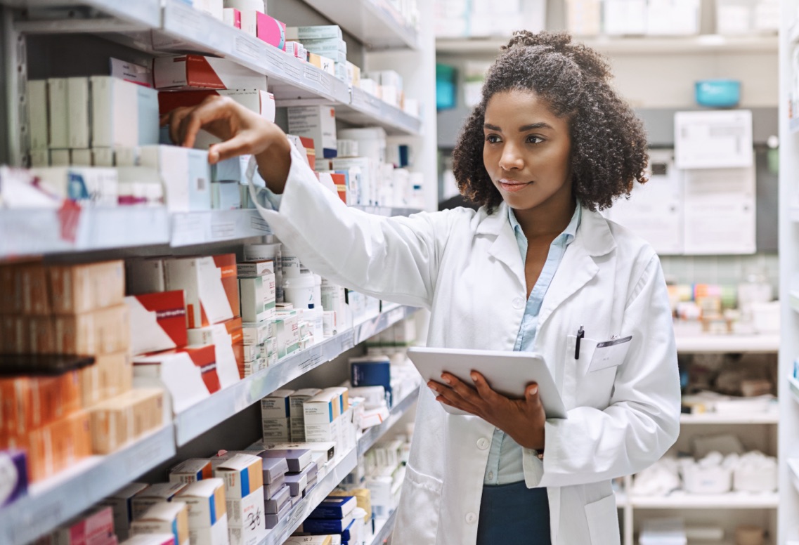 Photo of pharmacist putting medication on a shelf