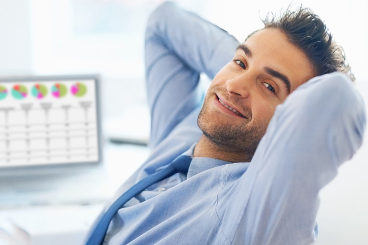 Man smiling, leaning back in chair