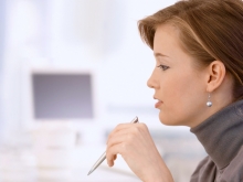 Side profile of woman holding a pen