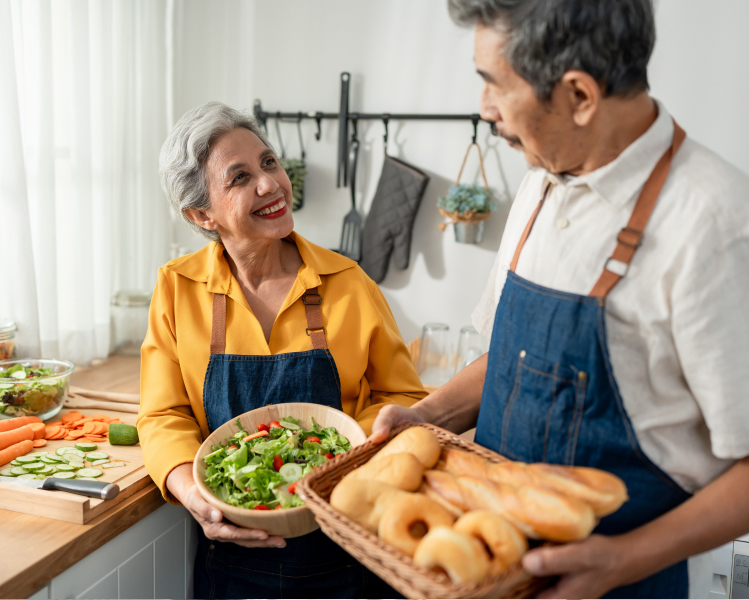 Photo of a senior couple making food together in the kitchen