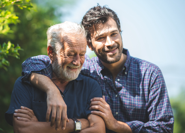 Senior father and adult son outside