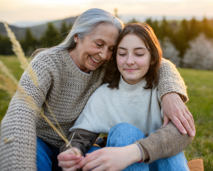 Photo of grandmother outside with her granddaughter